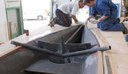 Sean  and Dan putting glue line on to attach foredeck